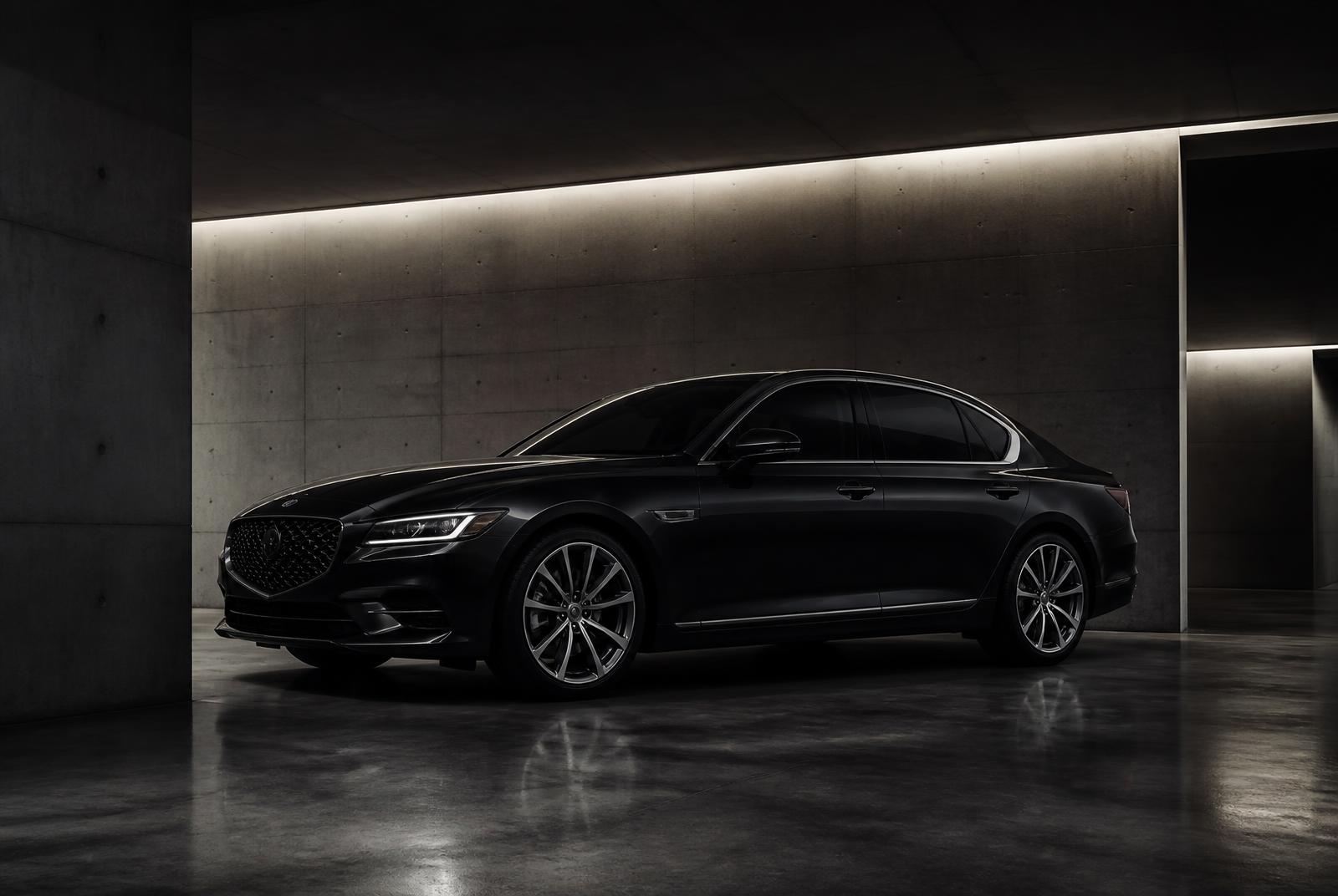 Black luxury sedan parked in a modern garage under silver rim lighting